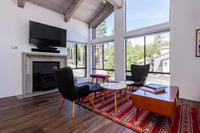 a living room with a fireplace and a tv at Courchevel C # 9 in Mammoth Lakes