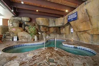 a swimming pool in a stone wall with a jacuzzi at Bally's Lake Tahoe Casino Resort in Stateline