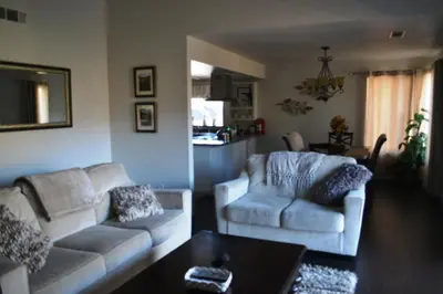 a living room with two couches and a table at Shady Knoll in Three Rivers