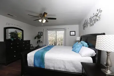 a bedroom with a bed and a ceiling fan at Shady Knoll in Three Rivers