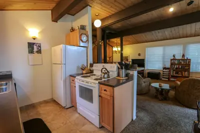 a kitchen with a white refrigerator and a stove at Timberline Condominium #44 in Mammoth Lakes