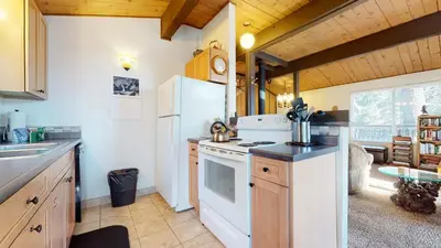 a kitchen with a white refrigerator and a stove at Timberline Condominium #44 in Mammoth Lakes