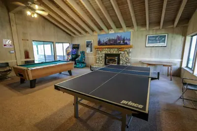 a room with a ping pong table and a fireplace at Sunshine Village #158 in Mammoth Lakes