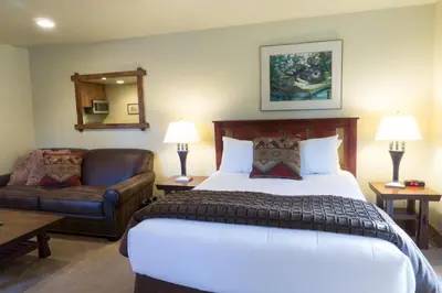 a hotel room with a bed and a couch and a bed and a chair at 3160 Aspen Grove in Truckee