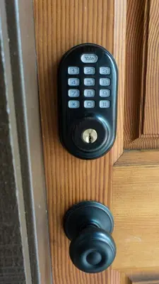 a black remote control on a wooden door at 3160 Aspen Grove in Truckee