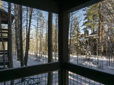 a view from a window of a snow covered yard at 3130 Aspen Grove in Truckee
