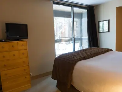 a bedroom with a bed and a television and a window at 3130 Aspen Grove in Truckee