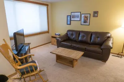 a living room with a leather couch and a table at 4081 Ski Trails in Truckee