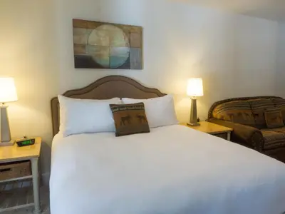 a bedroom with a white bed and two lamps at 3174 Aspen Grove in Truckee