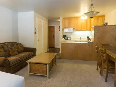 a living room and kitchen with a couch and a table at 3174 Aspen Grove in Truckee