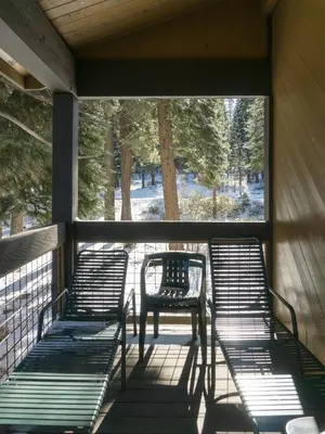 a porch with four chairs and a table on it at 3132 Aspen Grove in Truckee