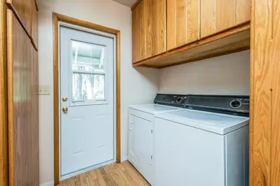 a small laundry room with a washer and dryer at Sparrow Cove in Shaver Lake