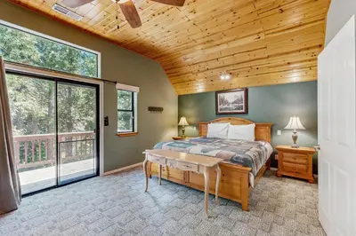 a bedroom with a bed and a wooden ceiling at The Rockin' Buffalo in Shaver Lake
