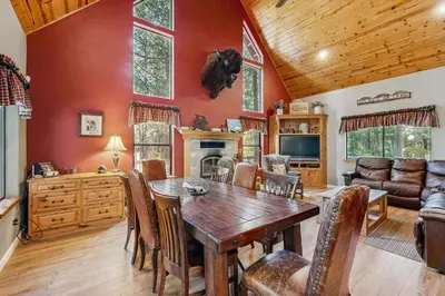 a dining room with a wooden table and chairs at The Rockin' Buffalo in Shaver Lake