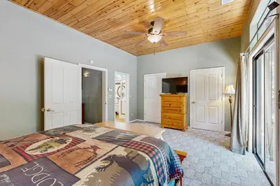 a bedroom with a bed and a ceiling fan at The Rockin' Buffalo in Shaver Lake