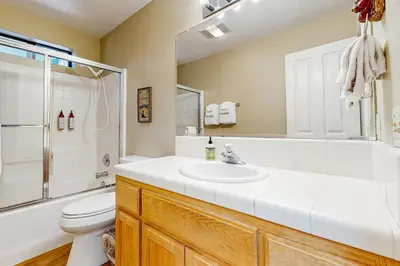 a bathroom with a sink and a shower and a toilet at The Rockin' Buffalo in Shaver Lake