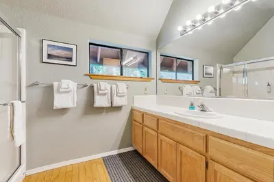 a bathroom with a white sink and a mirror at The Rockin' Buffalo in Shaver Lake
