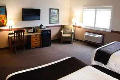 a hotel room with a bed and a desk with a television at Jackson Rancheria Casino Resort in Jackson