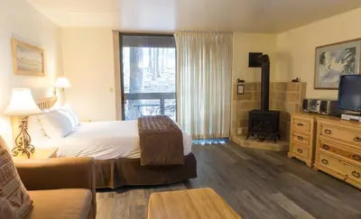 a hotel room with a bed and a fireplace at 3159 Aspen Grove in Truckee