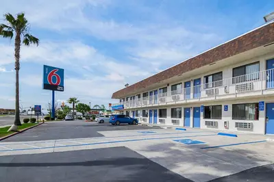 a hotel with a parking lot in front of it at Motel 6 Lost Hills / Buttonwillow Racetrack in Lost Hills
