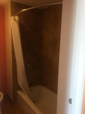 a bathroom with a shower with a bath tub at Motel 6 Lost Hills / Buttonwillow Racetrack in Lost Hills