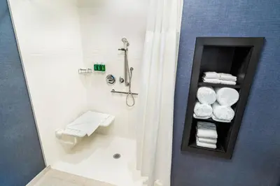 a bathroom with a shower and a toilet and towels at Residence Inn by Marriott Reno Sparks in Sparks