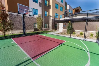 a tennis court with a basketball hoop on a building at Residence Inn by Marriott Reno Sparks in Sparks