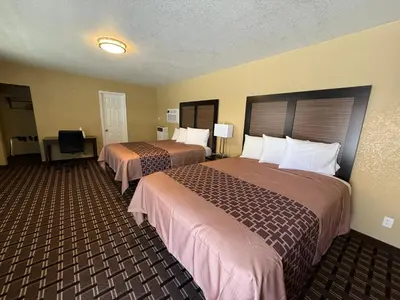 a hotel room with two beds and a desk at Tahoe Sands Inn in South Lake Tahoe
