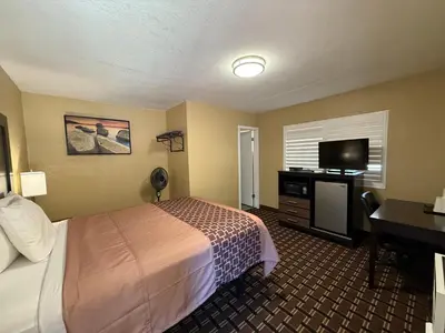 a hotel room with a bed and a flat screen tv at Tahoe Sands Inn in South Lake Tahoe