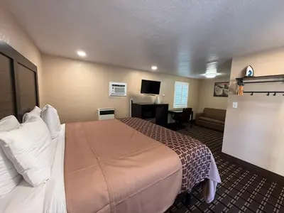 a hotel room with a large bed and a couch at Tahoe Sands Inn in South Lake Tahoe