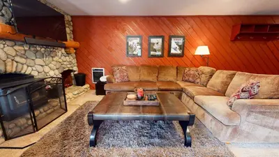 a living room with a couch and a table at Snowcreek 247 Townhouse in Mammoth Lakes