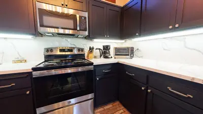 a kitchen with black cabinets and a stove and microwave at Snowcreek Iii #415 Condo in Mammoth Lakes
