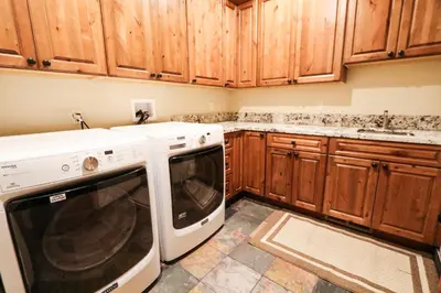 a kitchen with a white dishwasher and wooden cabinets at Gray Stone Condo #2110 in Mammoth Lakes