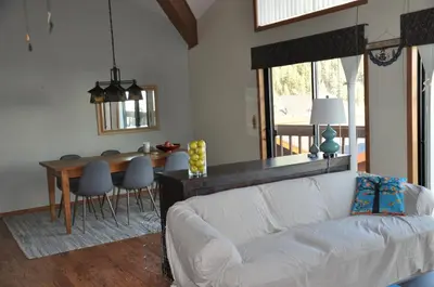 a living room with a white couch and a table at Bitterbrush - 400 Fairview Boulevard - very close to Diamond Peak and beaches - WSTR21-0086 - Tax ID W4900 - Max 7 people, 2 cars parking in carports in Incline Village