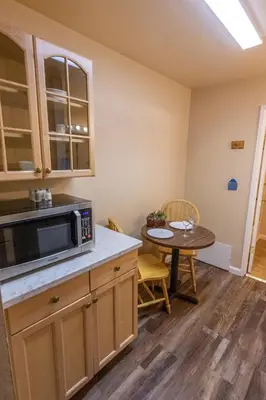 a kitchen with a table and a microwave at June Lake Motel in June Lake