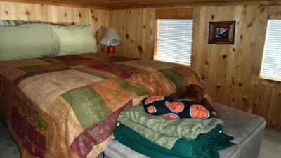 a bedroom with a large bed in a cabin at Cedar Pines Resort in South Lake Tahoe