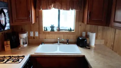a kitchen with a sink and a stove and a window at Cedar Pines Resort in South Lake Tahoe