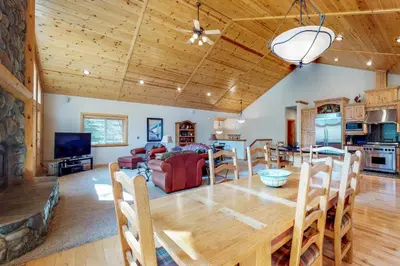 a dining room and living room with a large wooden table at Brookstone Haven in Truckee