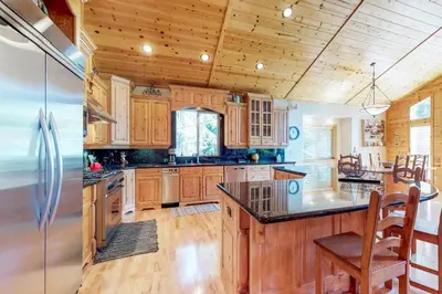 a kitchen with wooden cabinets and a stainless steel refrigerator at Brookstone Haven in Truckee