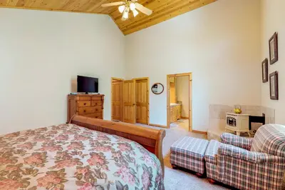 a bedroom with a bed and a couch and a tv at Brookstone Haven in Truckee