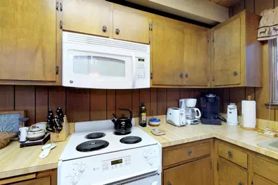 a kitchen with a white stove and a microwave at Bears Meadow in Arnold