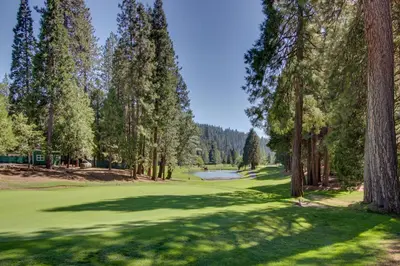 a view of a golf course with trees and a pond at Bears Meadow in Arnold