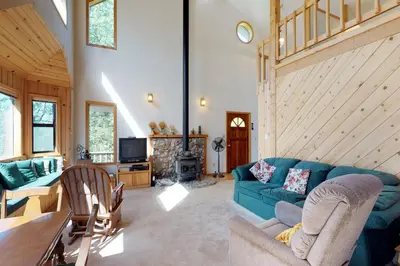 a living room with a blue couch and a fireplace at The Davis Classic in Arnold