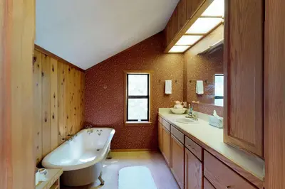 a bathroom with a white tub and a sink at The Davis Classic in Arnold