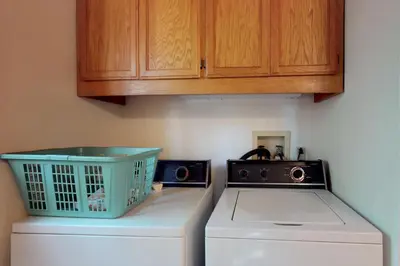 a kitchen with a refrigerator and a washing machine at The Davis Classic in Arnold