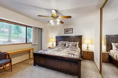 a bedroom with a bed and a ceiling fan at On The 9th in Arnold