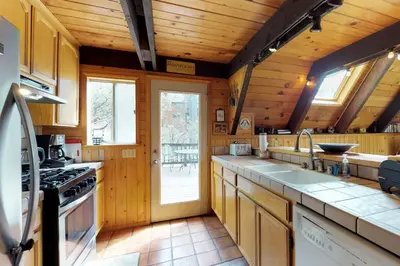 a kitchen with a sink and a stove at Stiles Mountain Hideaway in Arnold