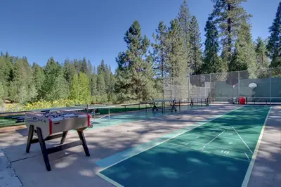 a tennis court with a ping pong table on it at Stiles Mountain Hideaway in Arnold