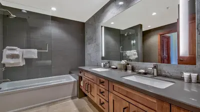 a bathroom with two sinks and a tub and a mirror at Zalanta 319 in South Lake Tahoe