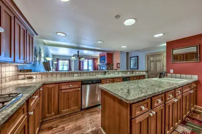 a large kitchen with wooden cabinets and granite counter tops at R110 Timber Ridge in Kirkwood